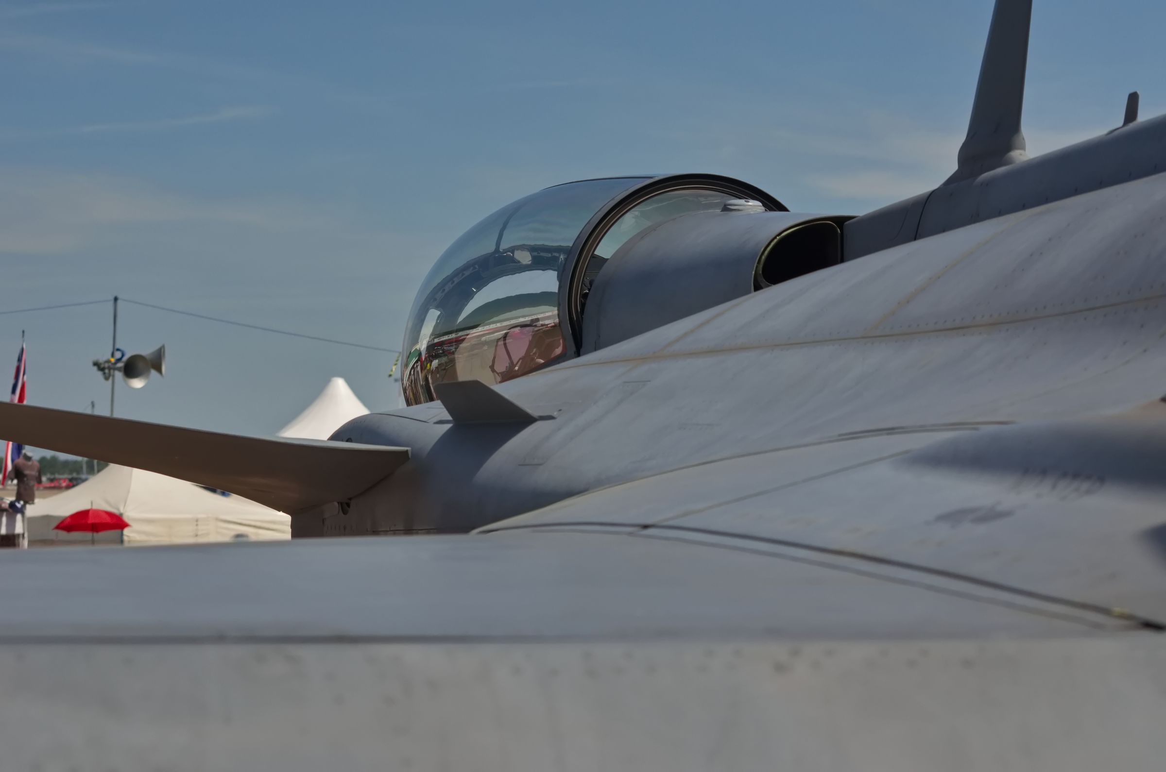 A view over the left wing of a static jet aircraft, looking towards the bubble cockpit, at RAF Fairford during RIAT 2022.