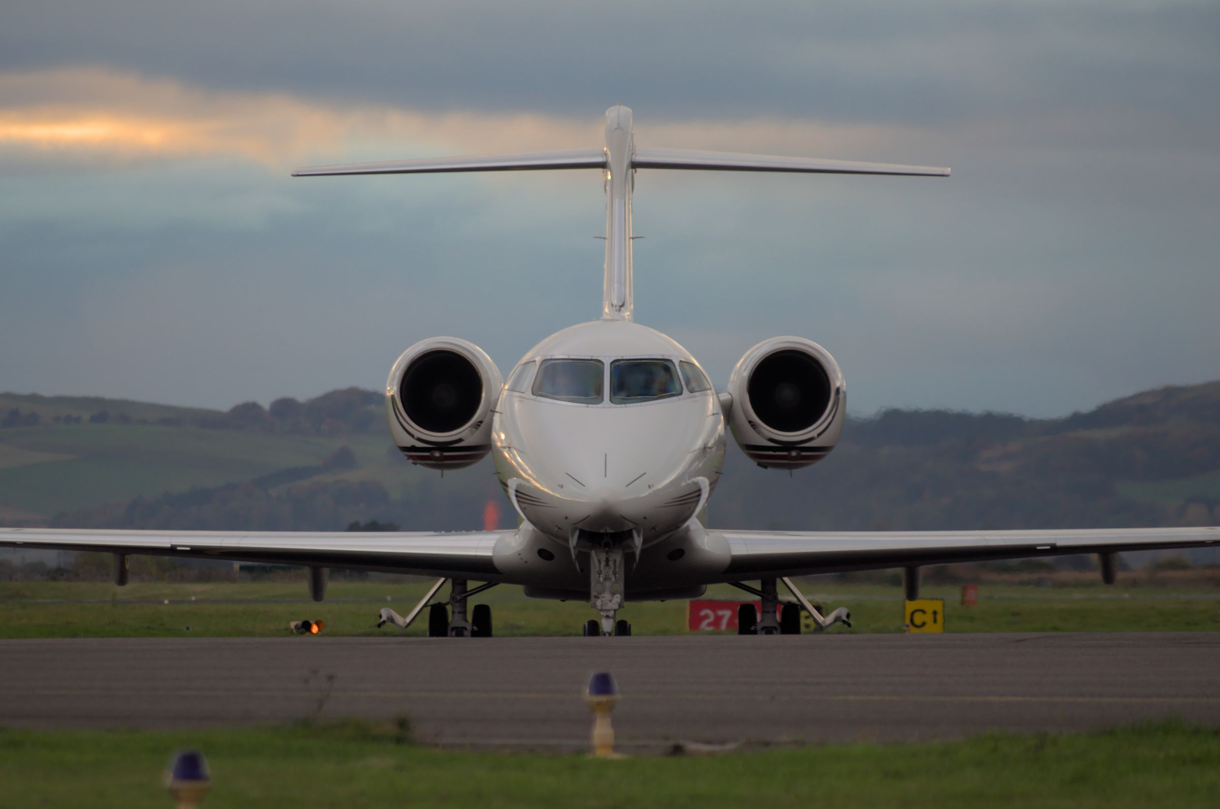 A Bombardier Challenger jet at Dundee Airport, viewed from the front.